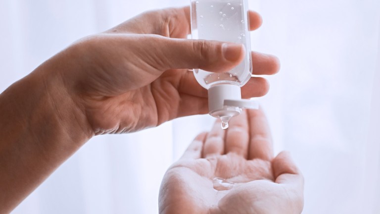 applying hand sanitiser