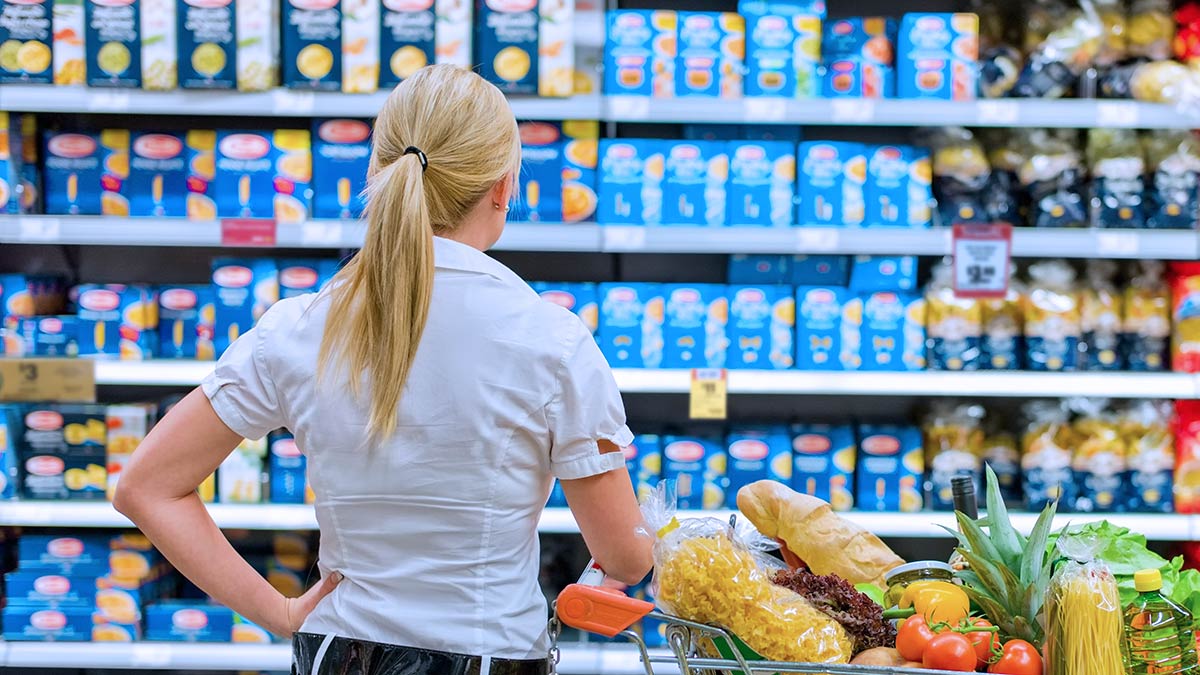 woman looking at unit pricing signs