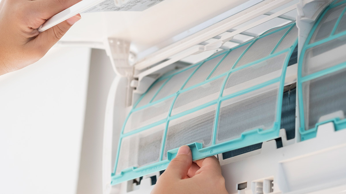 person_checking_filter_in_air_conditioner