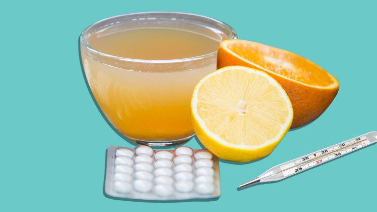 hot lemon drink with aspirin, lemon and thermometer