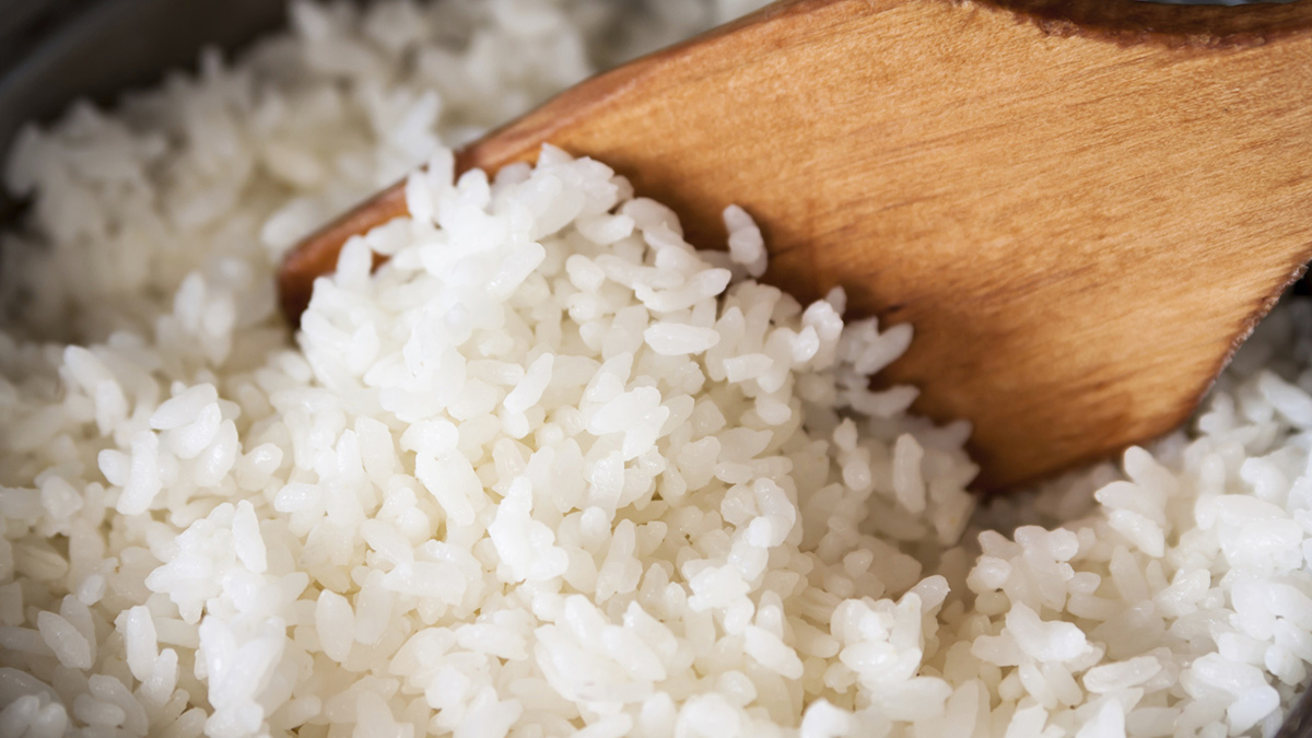 spooning rice out of a rice cooker