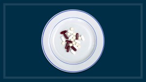 weight loss pills on a plate navy background