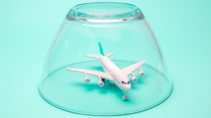 lead_plane_under_glass_cover_travel_canmcellations