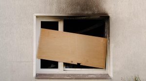 fire damage around broken window of home