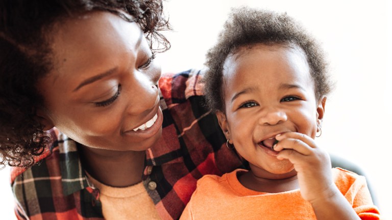 lead toddler eating with mother