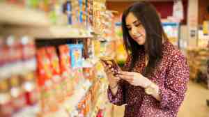 woman reading product label