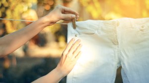 hanging white jeans on clothesline