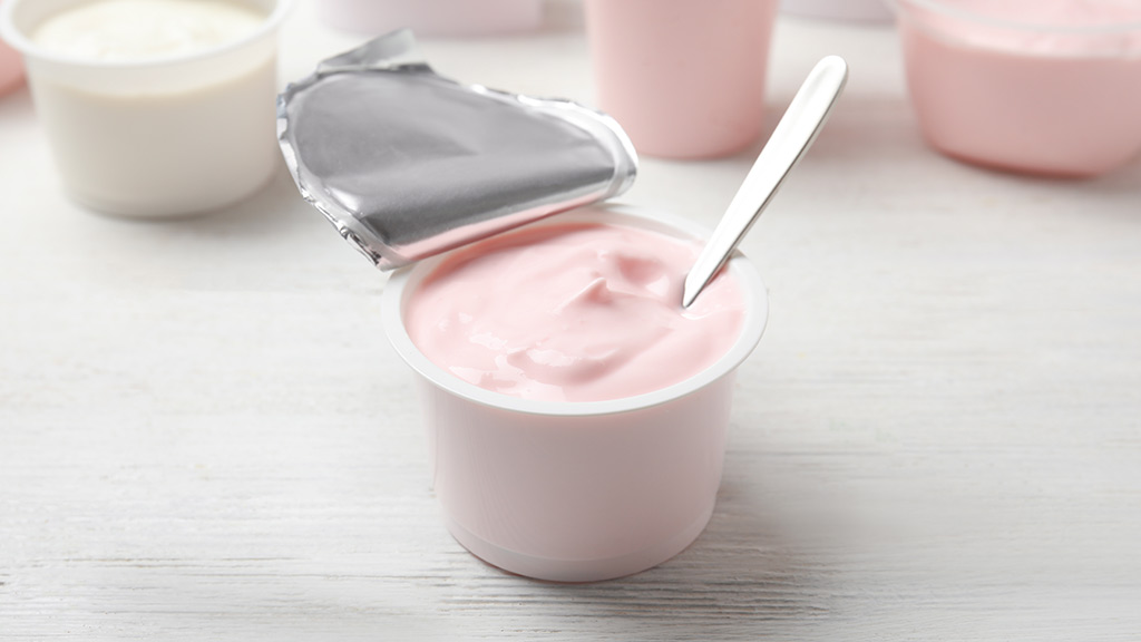 yogurt tubs on wooden background