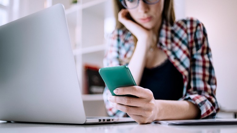 young_person_checking_social_media_on_smartphone