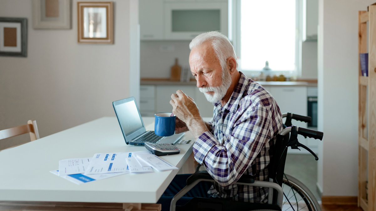person with disability looking at bills