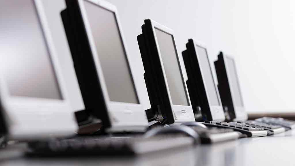 row of desktop computer screens