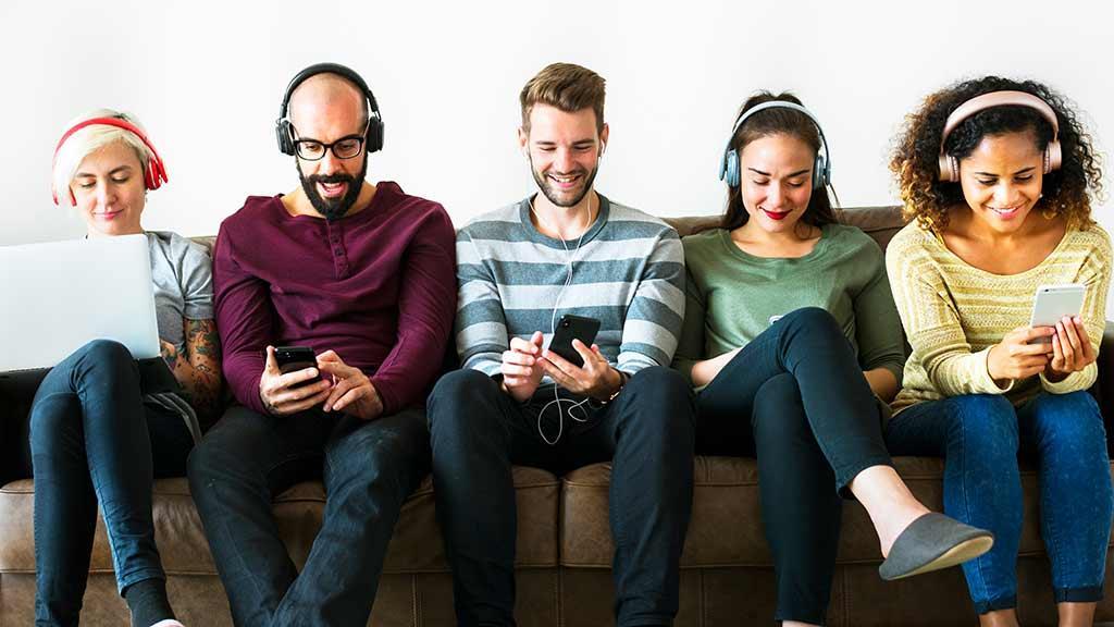 group_of_young_adults_using_5G_on_mobiles