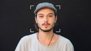 man with facial recognition scan on face