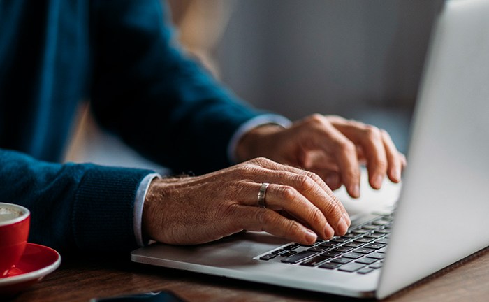 person_filling_out_survey_on_laptop