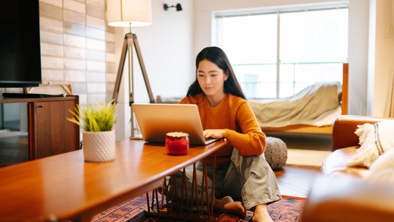 young_woman_looking_at_super_expenses_on_laptop