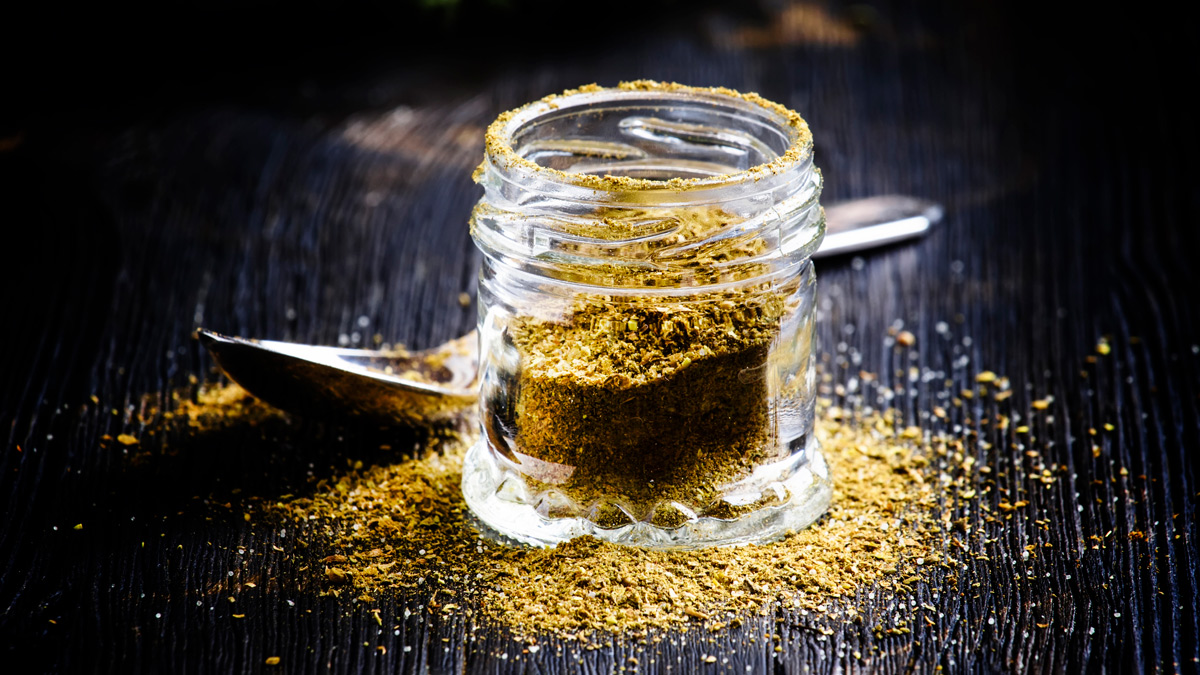 jar of ground spices on a wooden bench