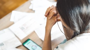 person_in_debt_looking_at_bills