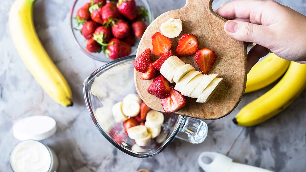 using a blender at home to blend fruit