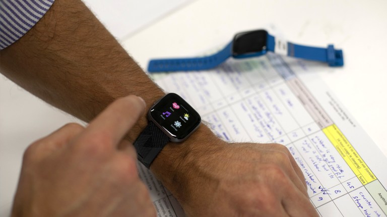 CHOICE tester in lab with fitness tracker on wrist