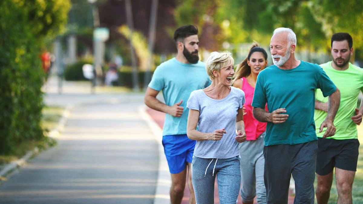 a group of men and women jogging outside together