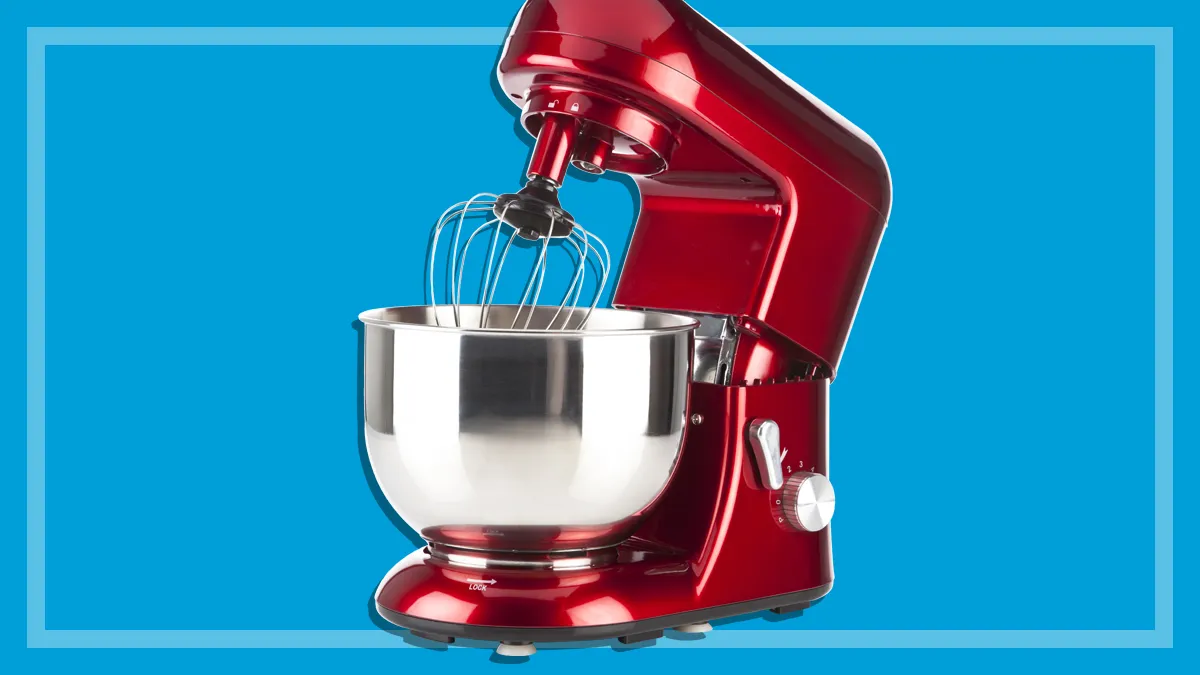 red benchtop stand mixer on a blue background
