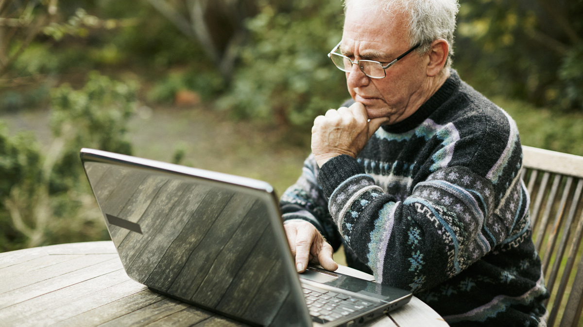 older man using laptop
