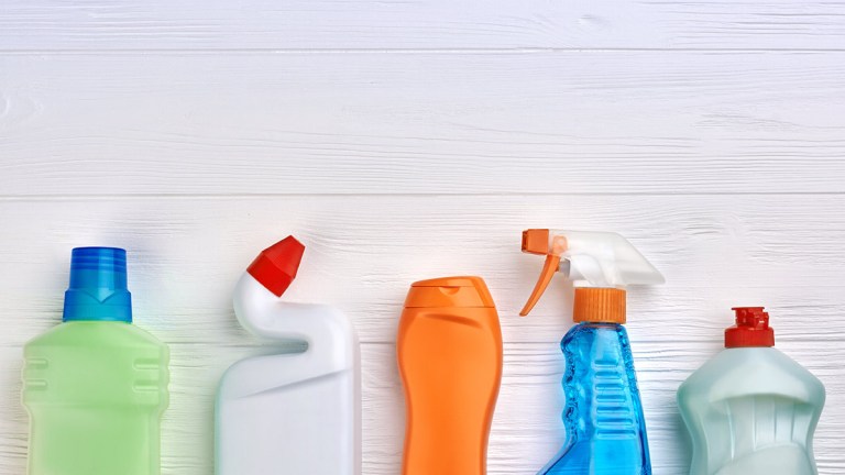 cleaning products lined up on a wooden background