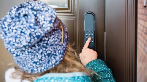woman using a keypad on a smart lock
