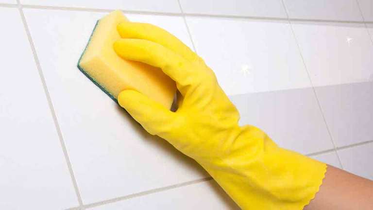 sponge cleaning bathroom tiles