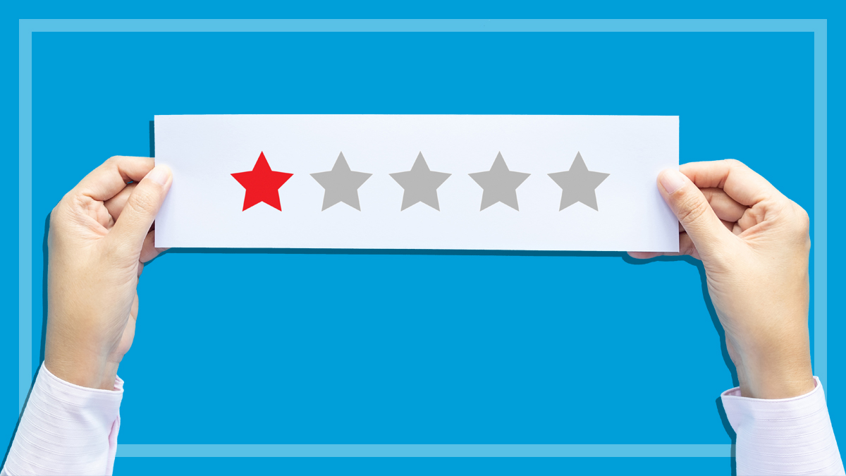 hands_holding_piece_of_paper_with_one_star_rating