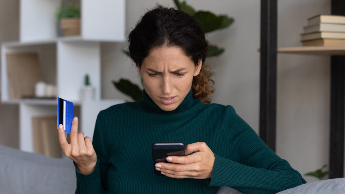 woman_checking_phone_scam_lead