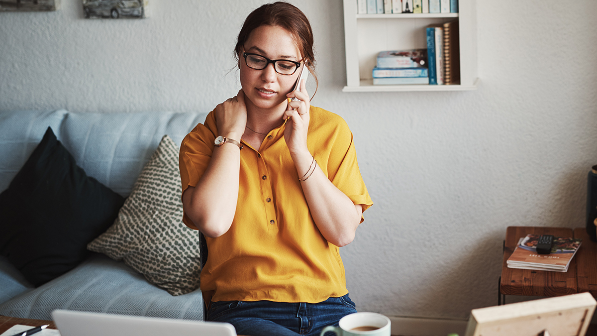 young_person_talking_to_scammer_on_phone_at_home