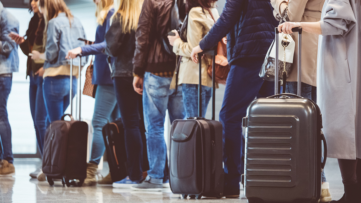 long_queue_of_people_waiting_to_board_or_check-in_for_flight
