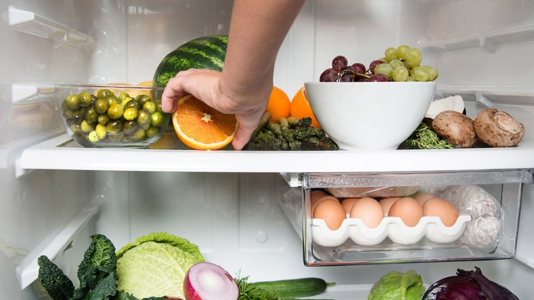 hand reaching into fridge