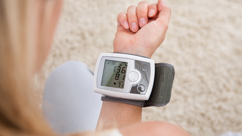 woman using blood pressure monitor lead