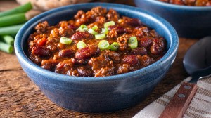 chilli shredded beef with beans in a blue bowl