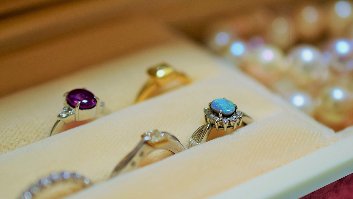 rings and a string of pearls in a jewellery box