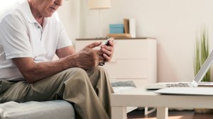 senior_person_reading_text_message_on_smartphone