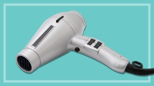 silver hair dryer on a teal background