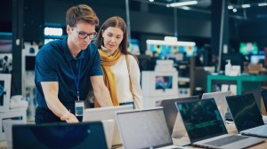 salesperson  recommending a laptop to a customer