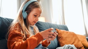 child watching movie or gaming on smartphone