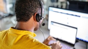 scammer_using_headset_and_laptop