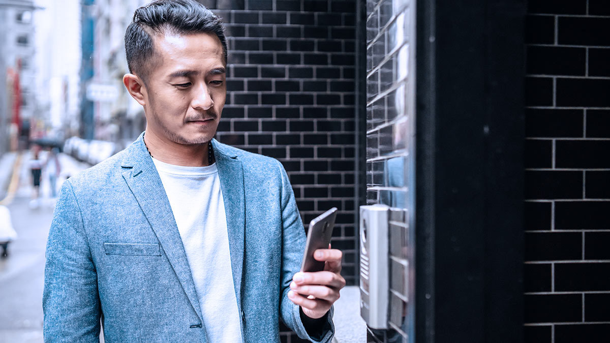 hwt_person_using_smartphone_to_open_front_door