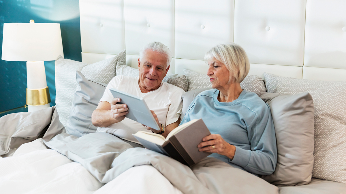 older couple reading in bed
