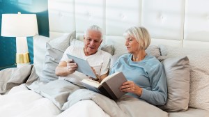 older couple reading in bed