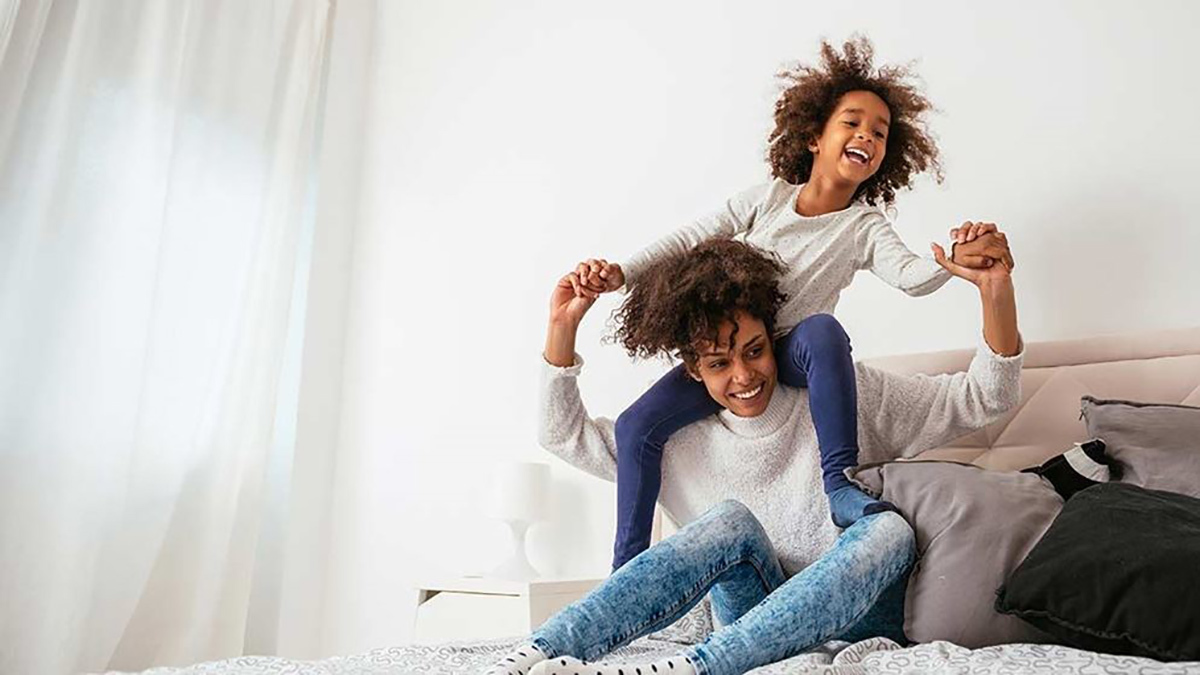 mother_and_child_playing_on_bed