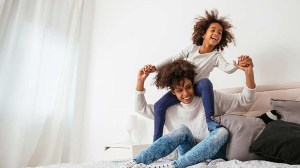 mother_and_child_playing_on_bed