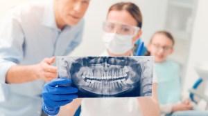 two people looking at an x-ray scan of wisdom teeth