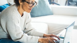 person using online home insurance calculator on laptop