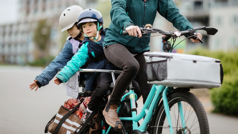 mother with two children and bags on an electric bike
